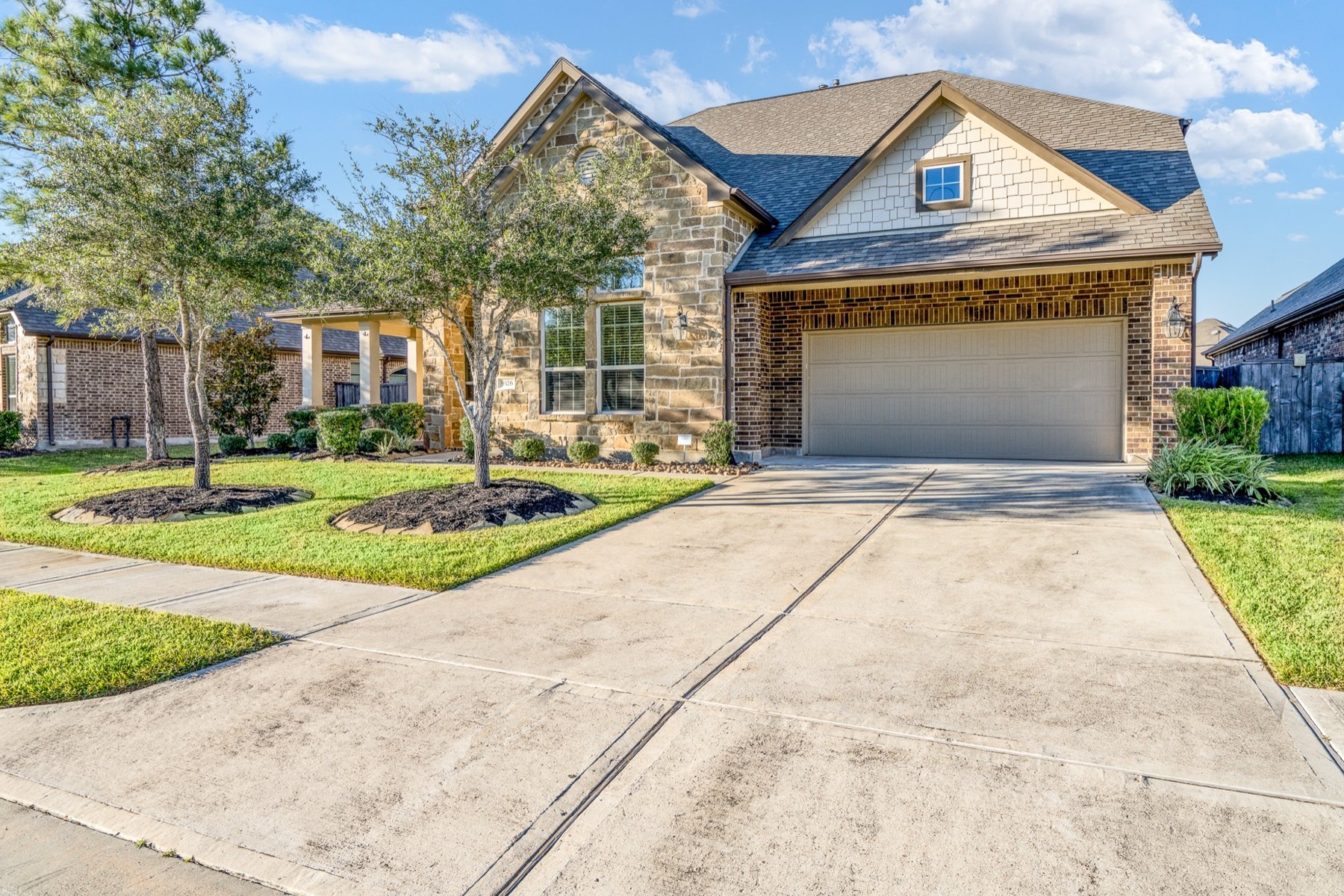 Stone and brick home with a front-facing garage